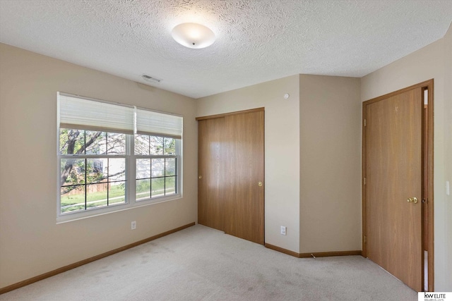 3909 N 147th St, Omaha, NE 68116 - unfurnished bedroom featuring a closet, carpet, a textured ceiling, and baseboards
