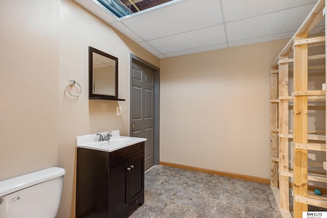 3909 N 147th St, Omaha, NE 68116 - half bath featuring vanity, a drop ceiling, toilet, and baseboards