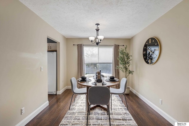 3909 N 147th St, Omaha, NE 68116 - dining area with a chandelier, dark wood-style floors, baseboards, and a textured ceiling