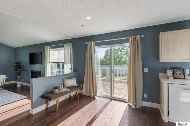 3909 N 147th St, Omaha, NE 68116 - living area featuring a textured ceiling, wood finished floors, baseboards, a glass covered fireplace, and recessed lighting