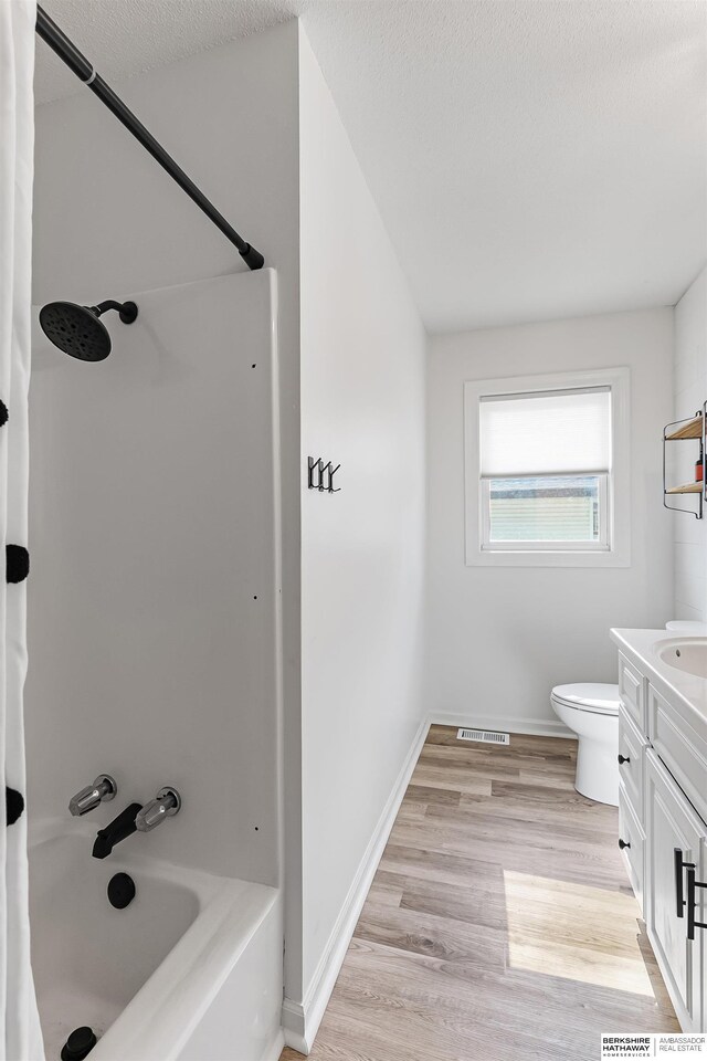 221 Lindale Cir, Hickman, NE 68372 - bathroom featuring vanity, shower / bath combo with shower curtain, toilet, wood finished floors, and baseboards