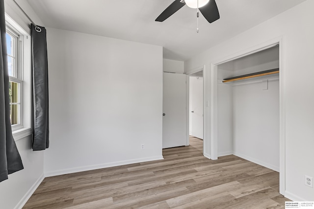 221 Lindale Cir, Hickman, NE 68372 - unfurnished bedroom featuring wood finished floors, ceiling fan, a closet, and baseboards