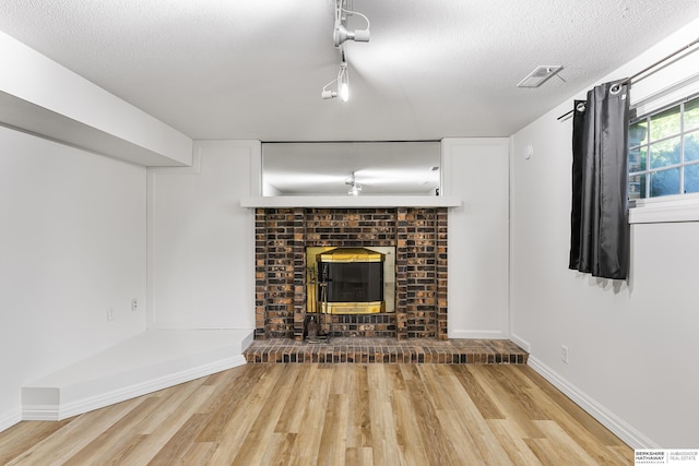 221 Lindale Cir, Hickman, NE 68372 - unfurnished living room with wood finished floors, baseboards, and a textured ceiling