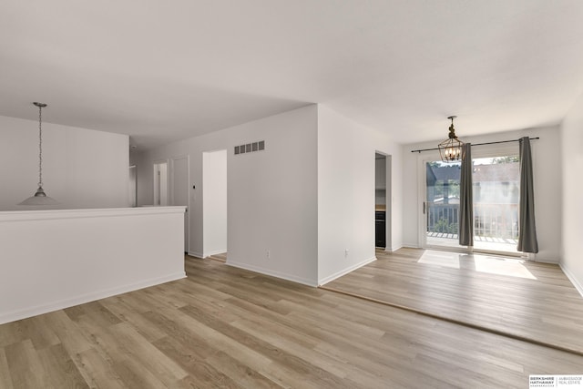 221 Lindale Cir, Hickman, NE 68372 - unfurnished living room featuring a chandelier, light wood-type flooring, and baseboards