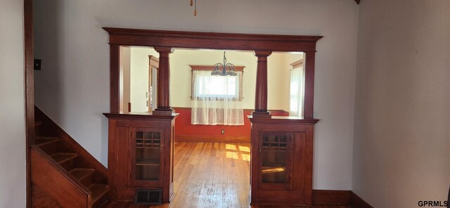 942 Manatt St, Lincoln, NE 68521 - hall with a chandelier, wood finished floors, baseboards, and stairs