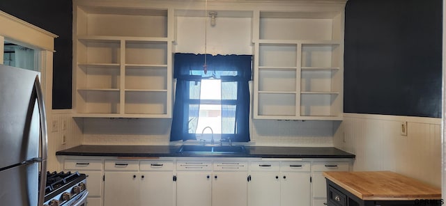 942 Manatt St, Lincoln, NE 68521 - kitchen with open shelves, stainless steel appliances, white cabinetry, and wainscoting