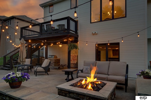 1411 S 195th St, Omaha, NE 68130 - patio terrace at dusk with stairs, an outdoor living space with a fire pit, and a deck