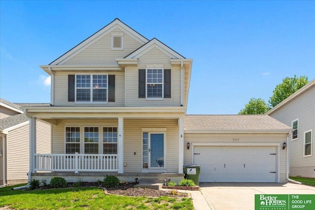 traditional home featuring a porch, driveway, and a garage