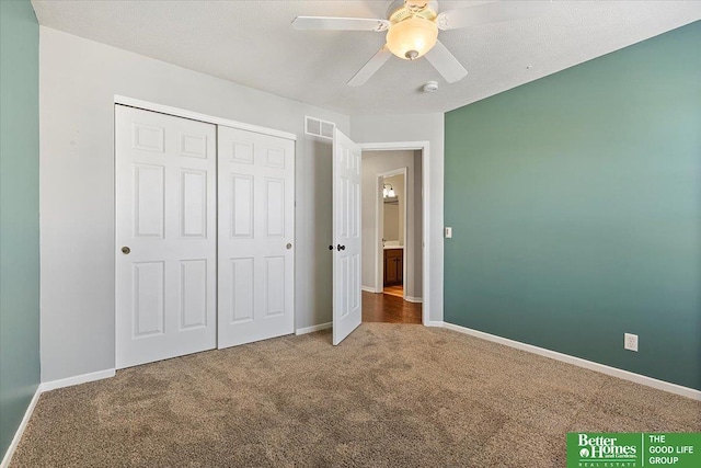 unfurnished bedroom with carpet flooring, baseboards, a closet, and ceiling fan