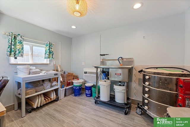 miscellaneous room with wood finished floors, recessed lighting, and a wall mounted air conditioner