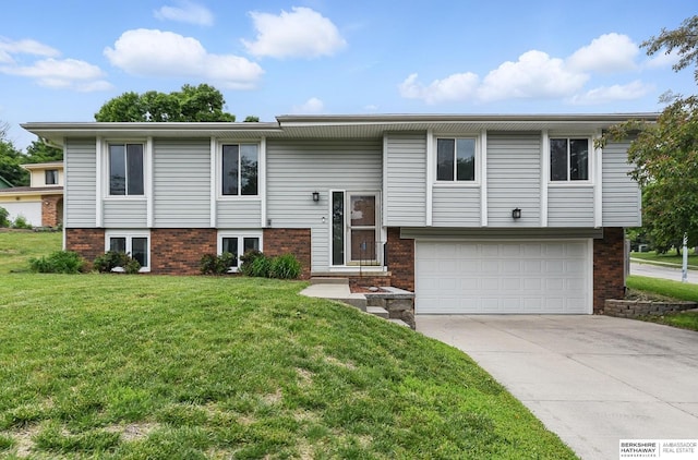 2908 S 160th Cir, Omaha, NE 68130 - split foyer home featuring a garage, a front yard, concrete driveway, and brick siding