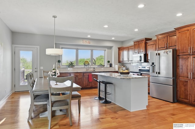 2614 N 191st Ave, Omaha, NE 68022 - kitchen featuring stainless steel appliances, a kitchen island, tasteful backsplash, recessed lighting, and light stone counters