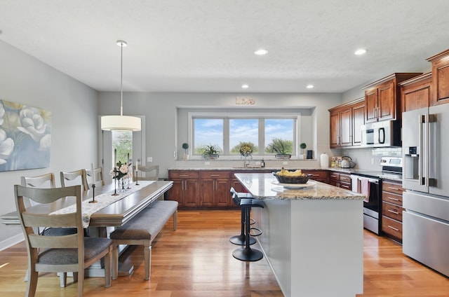 2614 N 191st Ave, Omaha, NE 68022 - kitchen with appliances with stainless steel finishes, plenty of natural light, light wood-type flooring, a center island, and recessed lighting