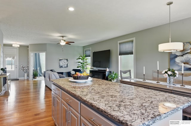 2614 N 191st Ave, Omaha, NE 68022 - kitchen featuring ceiling fan, light stone counters, light wood-style flooring, a kitchen island, and recessed lighting