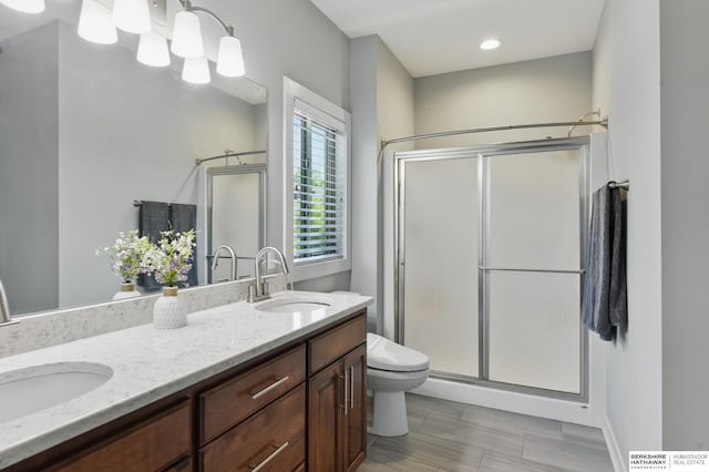 2614 N 191st Ave, Omaha, NE 68022 - full bathroom featuring a shower stall, double vanity, and toilet