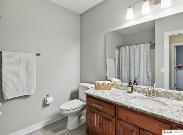 2614 N 191st Ave, Omaha, NE 68022 - full bath with toilet, baseboards, vanity, a shower with curtain, and tile patterned flooring