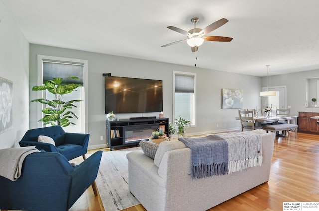 2614 N 191st Ave, Omaha, NE 68022 - living area featuring a ceiling fan, light wood-style flooring, and baseboards