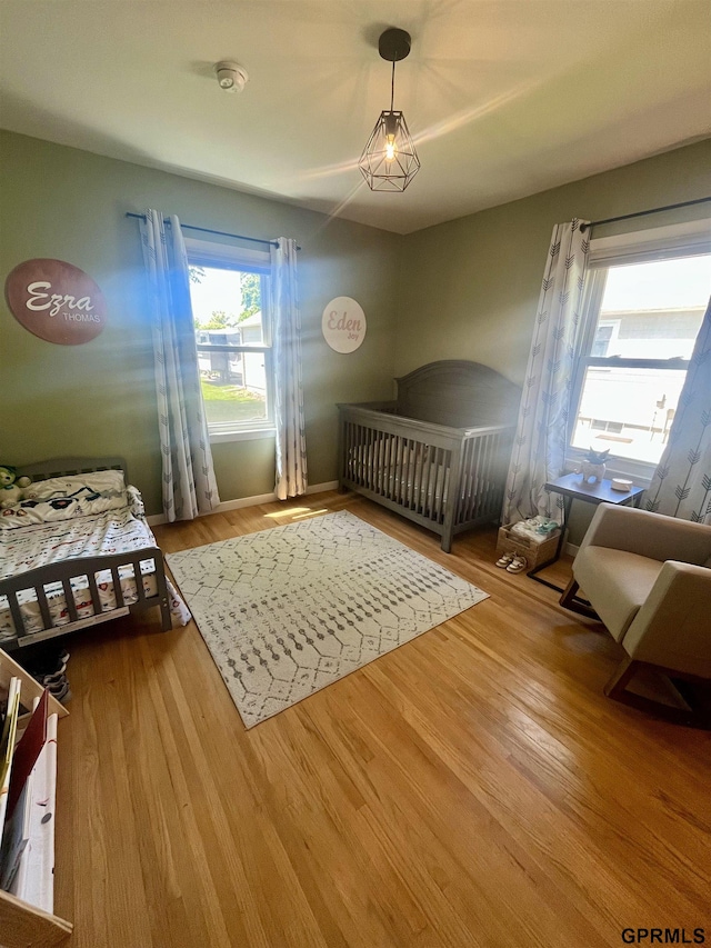 bedroom featuring wood finished floors and baseboards