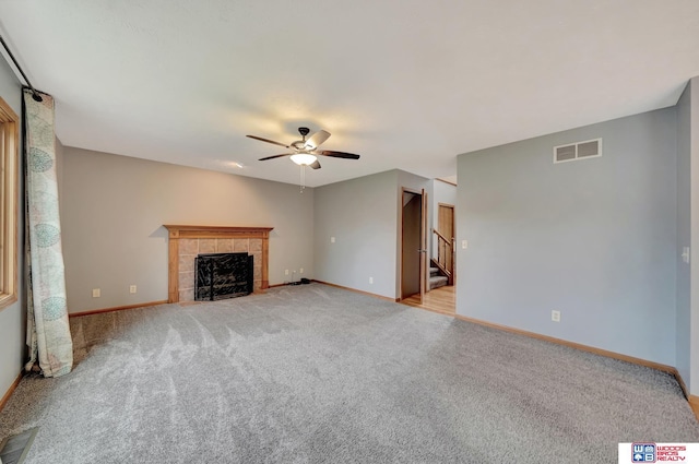 7910 Red Oak Rd, Lincoln, NE 68516 - unfurnished living room with ceiling fan, light carpet, baseboards, and a tiled fireplace