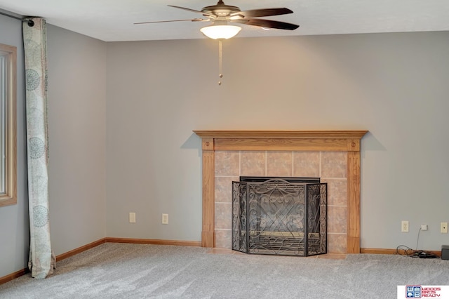 7910 Red Oak Rd, Lincoln, NE 68516 - unfurnished living room with ceiling fan, carpet flooring, baseboards, and a tile fireplace