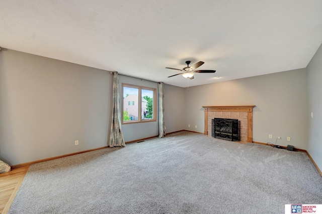 7910 Red Oak Rd, Lincoln, NE 68516 - unfurnished living room with a ceiling fan, baseboards, a fireplace, and light colored carpet