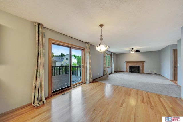 7910 Red Oak Rd, Lincoln, NE 68516 - unfurnished living room with wood finished floors, a fireplace, baseboards, and a ceiling fan