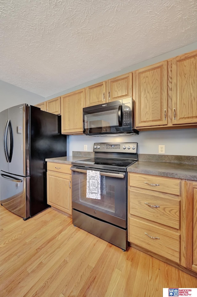 7910 Red Oak Rd, Lincoln, NE 68516 - kitchen featuring stainless steel appliances, light brown cabinets, light wood-type flooring, and a textured ceiling