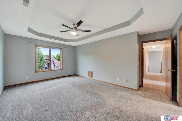 7910 Red Oak Rd, Lincoln, NE 68516 - empty room with a raised ceiling, light carpet, a ceiling fan, and baseboards