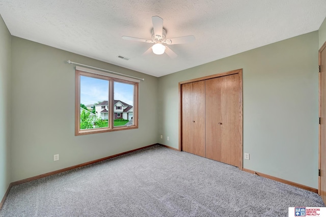7910 Red Oak Rd, Lincoln, NE 68516 - unfurnished bedroom featuring carpet flooring, baseboards, a closet, ceiling fan, and a textured ceiling