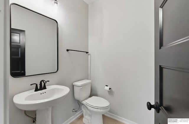 5413 N 212th St, Omaha, NE 68022 - half bathroom featuring baseboards, toilet, and a sink