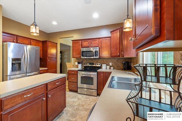 kitchen featuring stainless steel appliances, light countertops, tasteful backsplash, hanging light fixtures, and recessed lighting