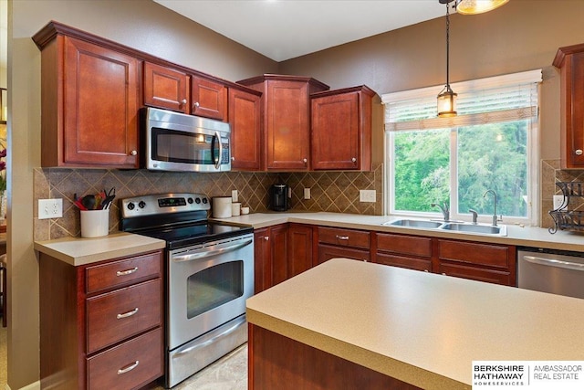 kitchen with stainless steel appliances, a sink, pendant lighting, decorative backsplash, and light countertops