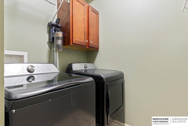 laundry area featuring cabinet space, independent washer and dryer, and baseboards