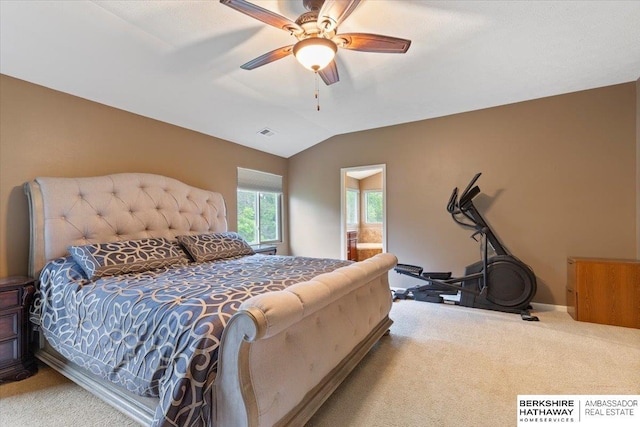 carpeted bedroom featuring vaulted ceiling, baseboards, a ceiling fan, and ensuite bath