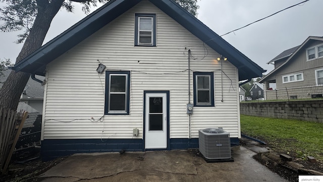 rear view of property with central AC and a patio