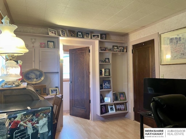 1200 H St, Pawnee City, NE 68420 - interior space featuring light wood-style floors, ornamental molding, and built in shelves