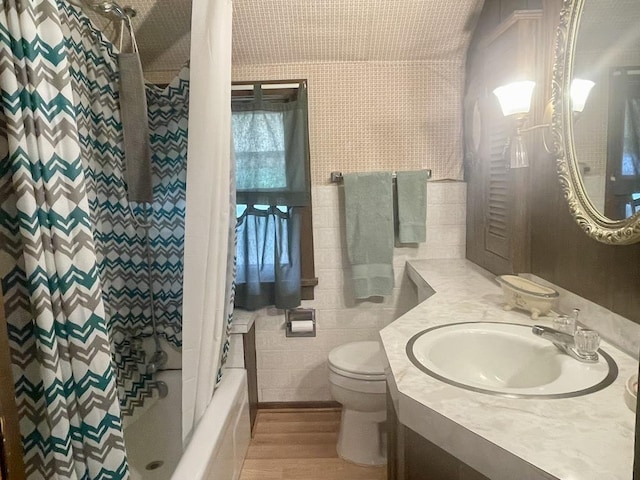 1200 H St, Pawnee City, NE 68420 - bathroom featuring wood finished floors, toilet, vanity, and shower / bathtub combination with curtain