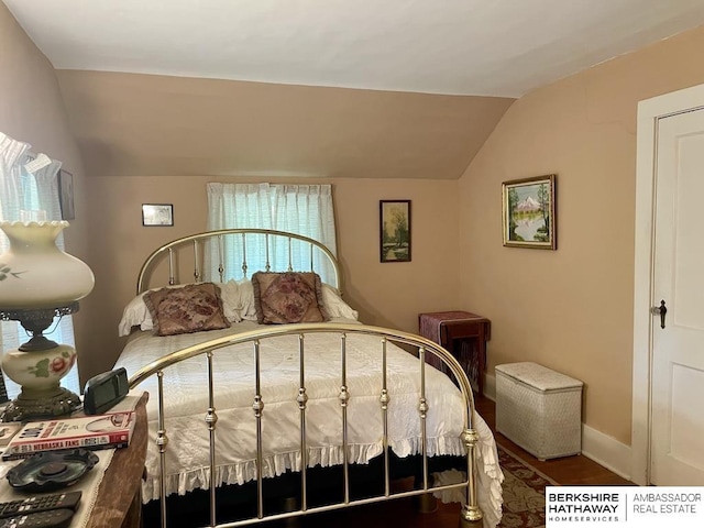 1200 H St, Pawnee City, NE 68420 - bedroom featuring vaulted ceiling, wood finished floors, and baseboards