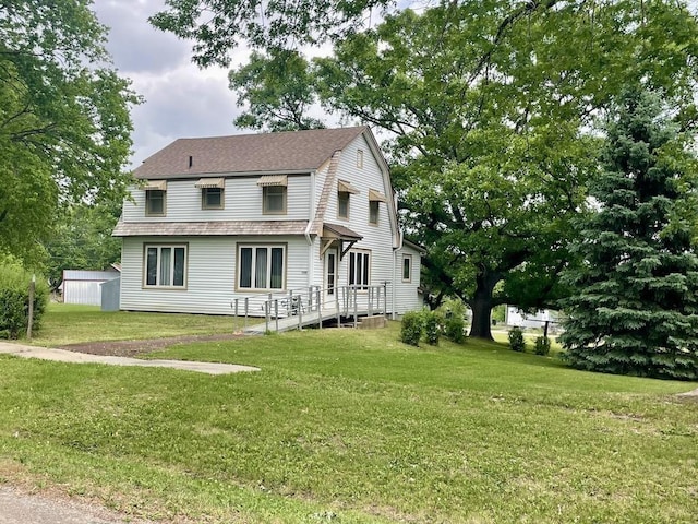 1200 H St, Pawnee City, NE 68420 - view of front facade featuring a front yard and a shingled roof