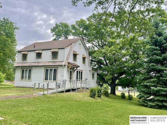 1200 H St, Pawnee City, NE 68420 - rear view of property featuring a gambrel roof, a lawn, and a shingled roof