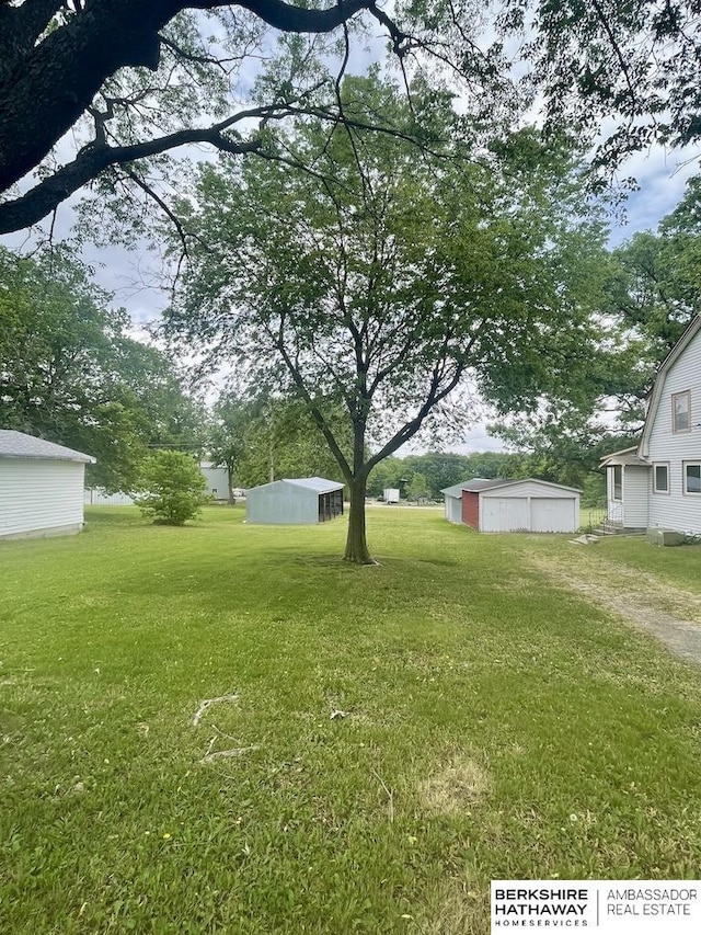 1200 H St, Pawnee City, NE 68420 - view of green lawn with a garage and an outdoor structure