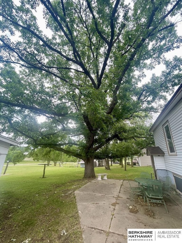 1200 H St, Pawnee City, NE 68420 - view of green lawn featuring a patio