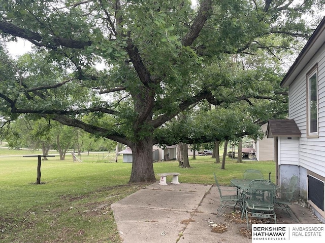 1200 H St, Pawnee City, NE 68420 - view of green lawn with a patio area