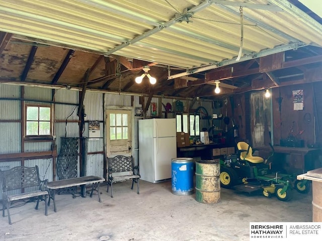1200 H St, Pawnee City, NE 68420 - garage featuring freestanding refrigerator and a workshop area