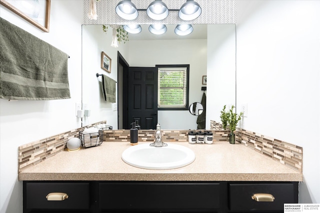 bathroom featuring tasteful backsplash and vanity