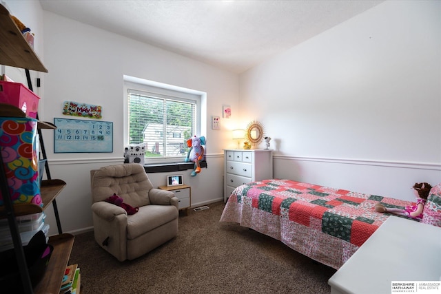 carpeted bedroom featuring baseboards