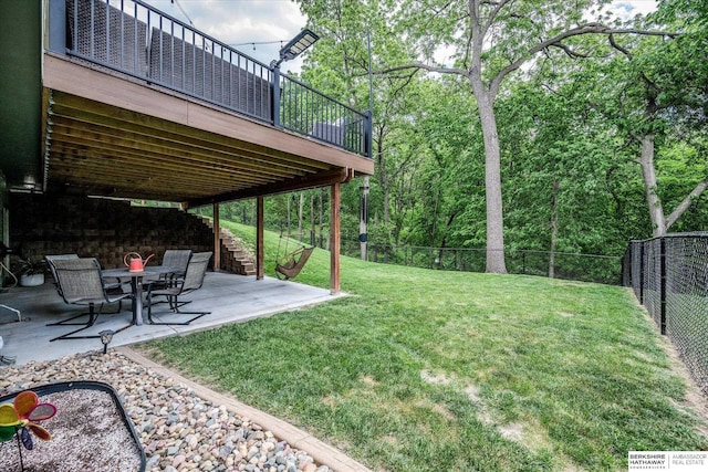 view of yard with a patio, a wooden deck, and stairway