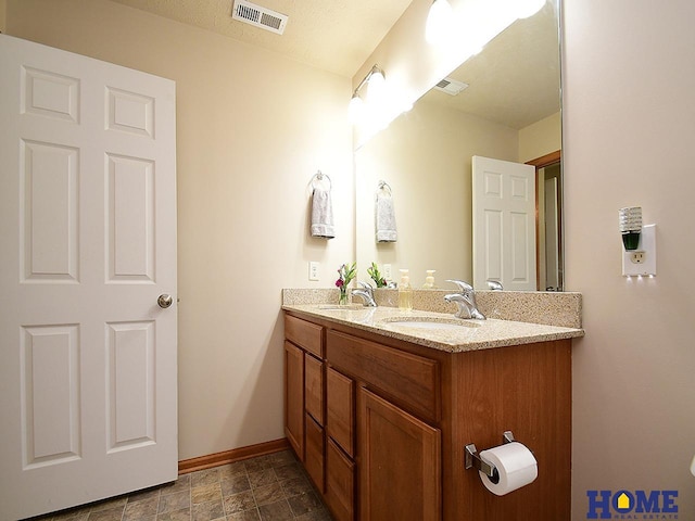 8946 Broken Spoke Dr, Lincoln, NE 68507 - bathroom featuring baseboards and double vanity