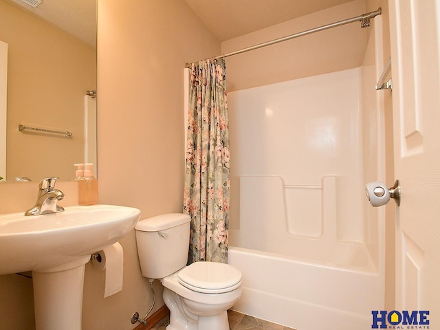 8946 Broken Spoke Dr, Lincoln, NE 68507 - full bathroom with toilet, shower / bath combo with shower curtain, tile patterned flooring, a sink, and baseboards