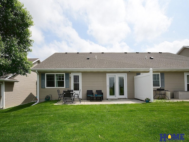 8946 Broken Spoke Dr, Lincoln, NE 68507 - back of house with a patio, a lawn, and a shingled roof